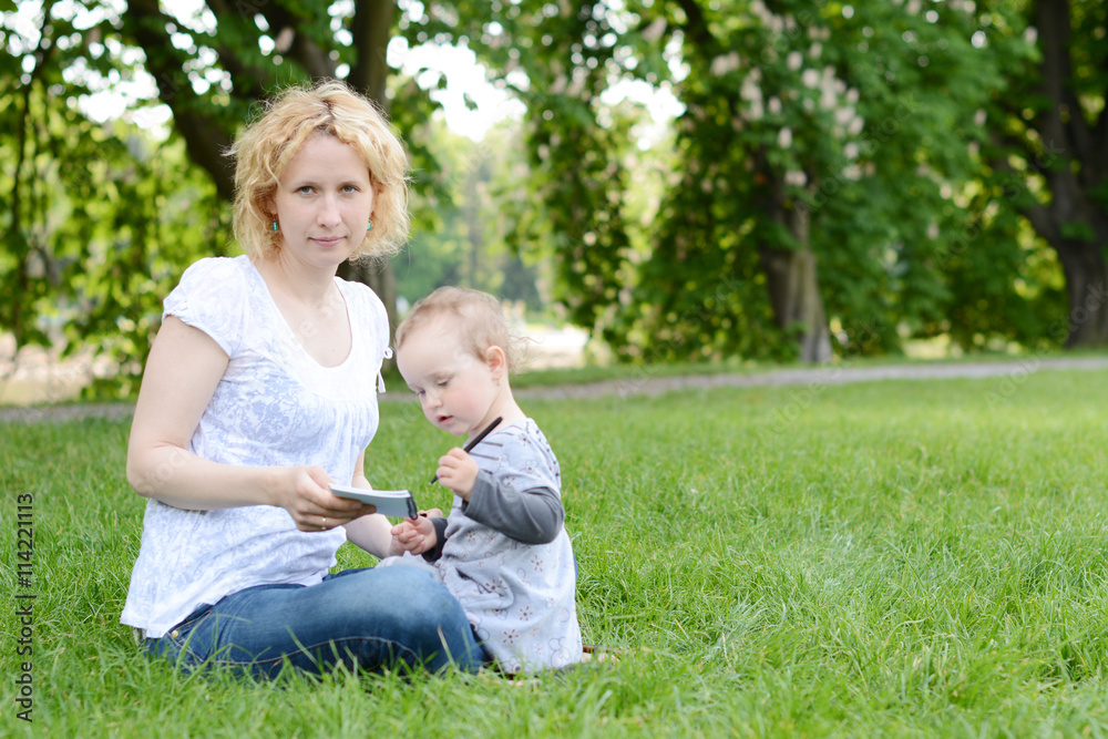 Beautiful young woman with her baby in the park. Beautiful young woman with her baby in the park.