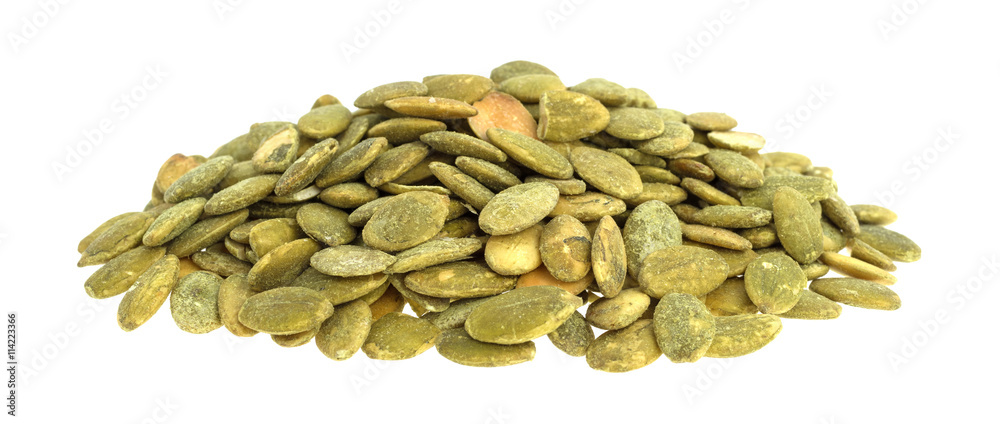 Organic dry roasted pumpkin seeds on a white background. Organic dry roasted pumpkin seeds on a white background.