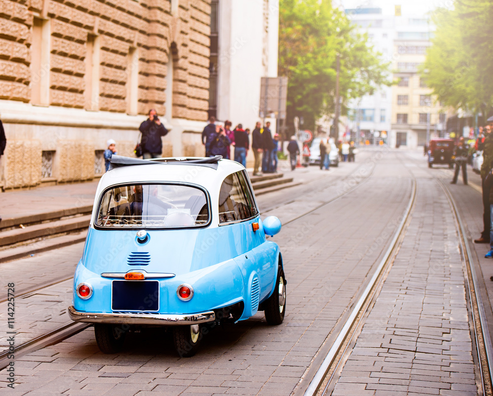 Fototapeta premium Veteran car street cruise on public roads. rear view