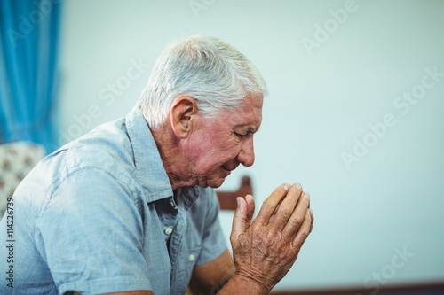 Wallpaper Mural Worried senior man sitting in living room  Torontodigital.ca
