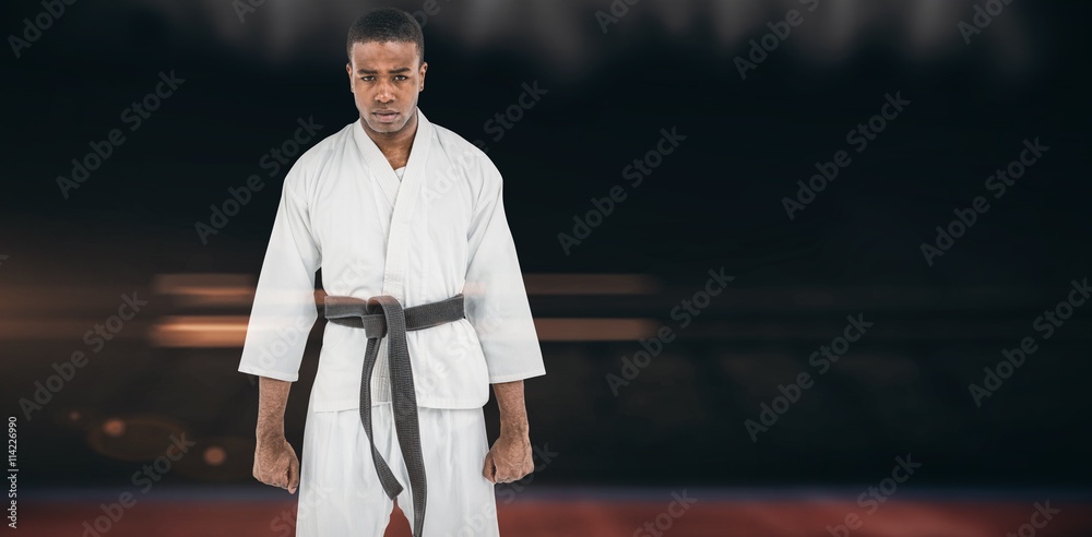 Naklejka premium Composite image of portrait of serious karate player