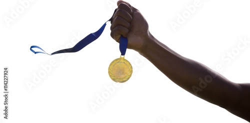 Hand holding a gold medal 