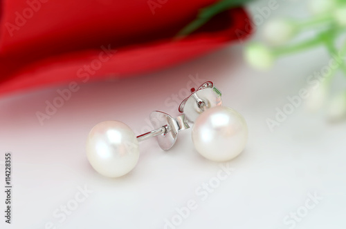 Pearl Earring on flower blur background