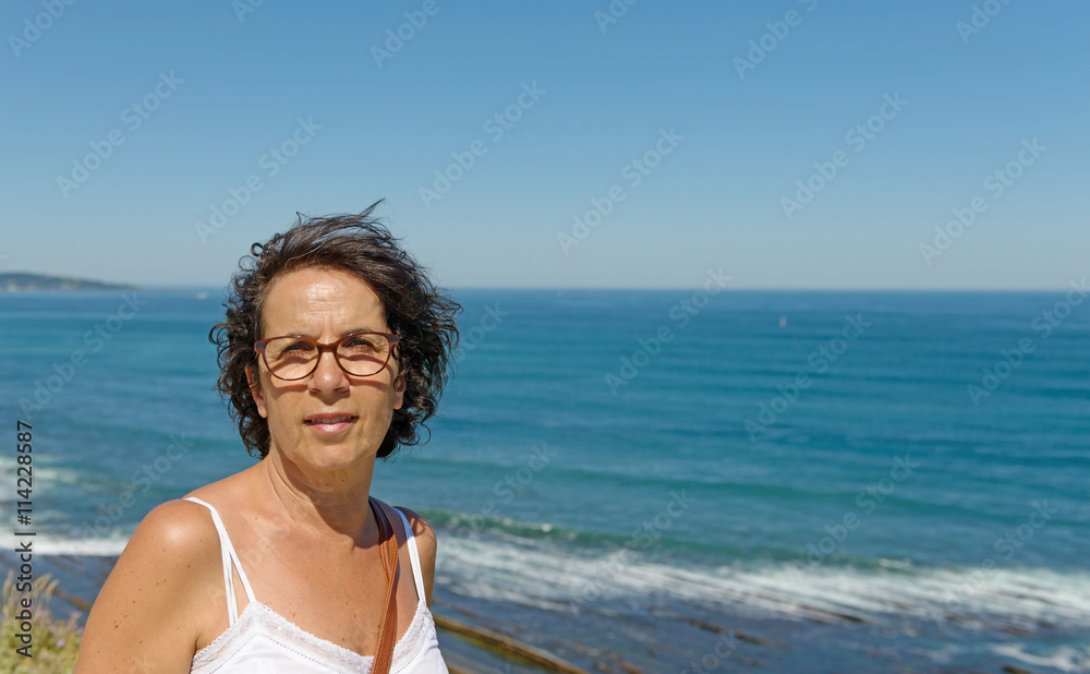 beautiful smiling woman, on the background of blue sea beautiful smiling woman, on the background of blue sea
