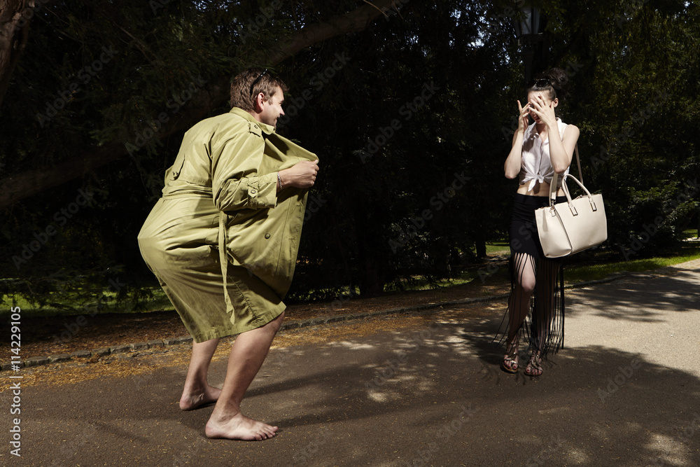 Fototapeta premium Bad surprise for young lady in park - harassing pervert