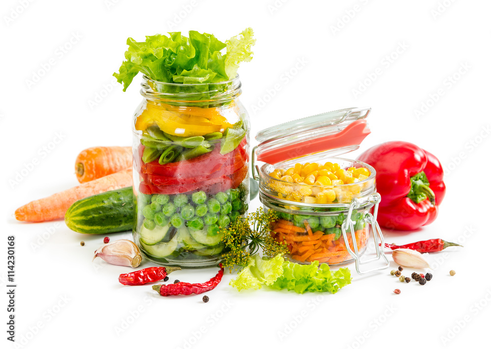 Colorful vegetables in glass jars Colorful vegetables in glass jars