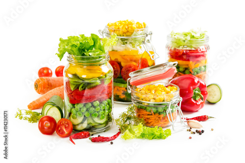 Colorful vegetables in glass jars