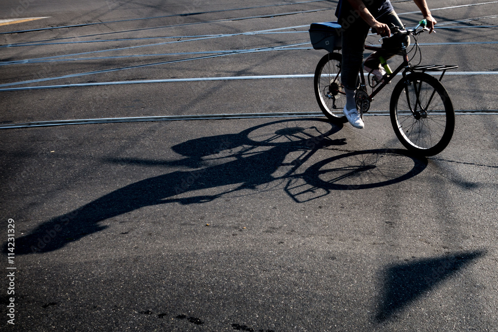 Fototapeta premium Ciclista che pedala per le strade cittadine sulla sua bicicletta