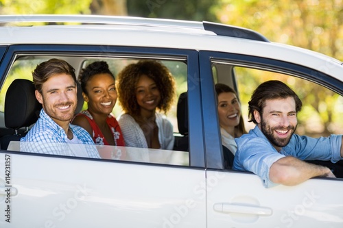 Group of friends looking out from car window