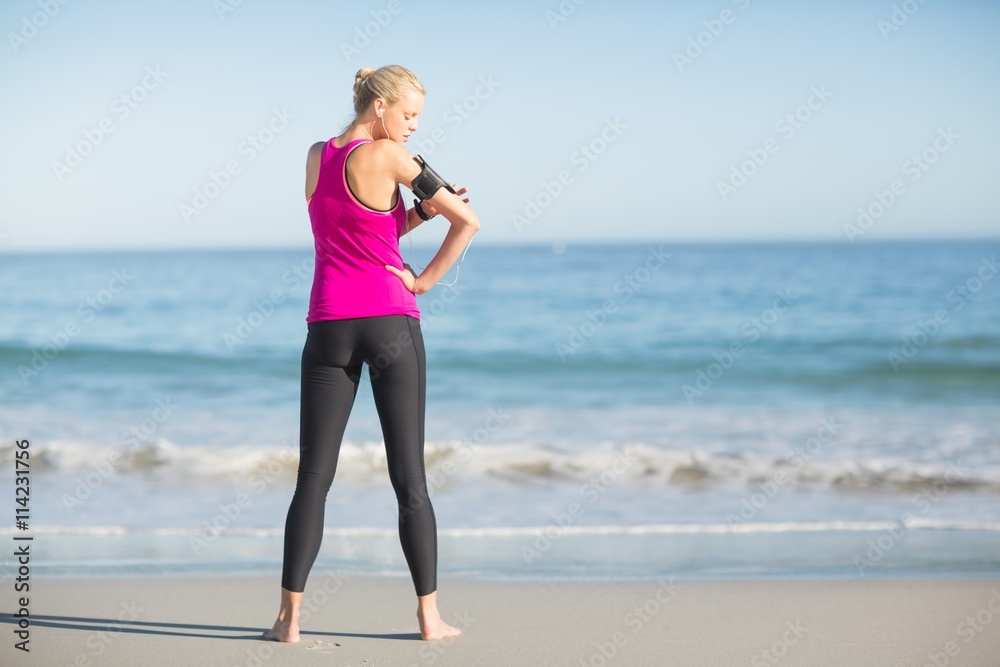 Sportswoman using mobile phone on beach Sportswoman using mobile phone on beach