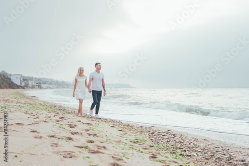 young loving couple having fun on beach