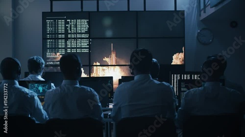 Group of People in Mission Control Center filled with Displays, Celebrating Successful Rocket Launch. Elements of this image furnished by NASA photo