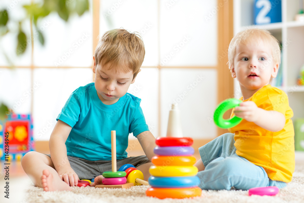 Toddlers kids playing with wooden blocks at home Stock Photo | Adobe Stock