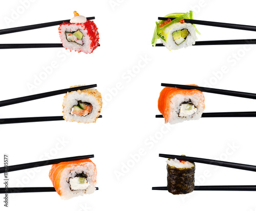 sushi roll in chopsticks Isolated on white