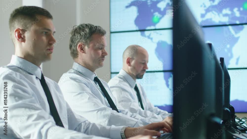 Team of IT Professionals Working at the Computers in Bright Office. Shot on RED Cinema Camera in 4K (UHD). Team of IT Professionals Working at the Computers in Bright Office. Shot on RED Cinema Camera in 4K (UHD).