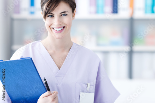 Smiling doctor holding medical reports