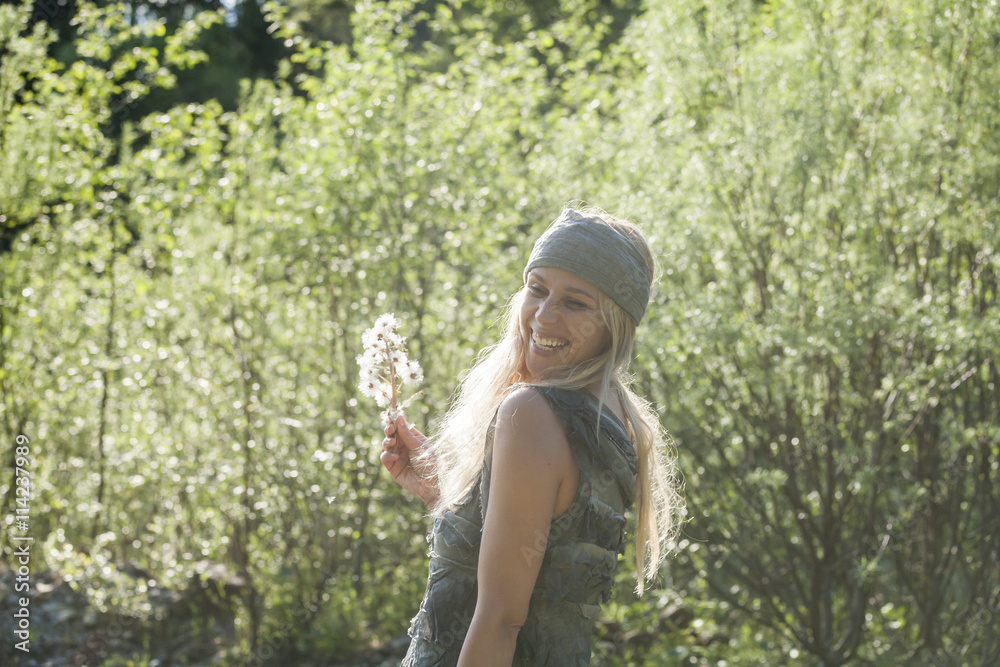 Portrait of laughing blond woman with an umbel in nature Portrait of laughing blond woman with an umbel in nature