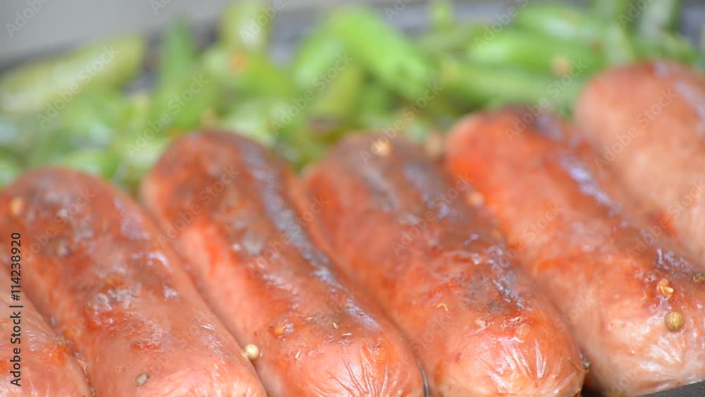 Sausages fried with green beans, sprinkled with ketchup Sausages fried with green beans, sprinkled with ketchup