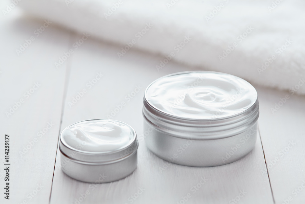 Cosmetic cream lotion white organic beauty moisturizer cleansing acne product with towel on white background. Dermatology hygienic anti aging, wrinkles, blemish, pimples, blackheads clear treatment Cosmetic cream lotion white organic beauty moisturizer cleansing acne product with towel on white background. Dermatology hygienic anti aging, wrinkles, blemish, pimples, blackheads clear treatment