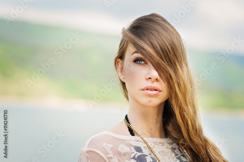 Gorgeous blode young woman on the beach in summer photo