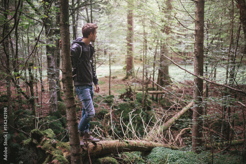 Young man standing in the forest