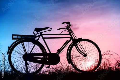beautiful landscape image with Silhouette Bicycle at sunset in
