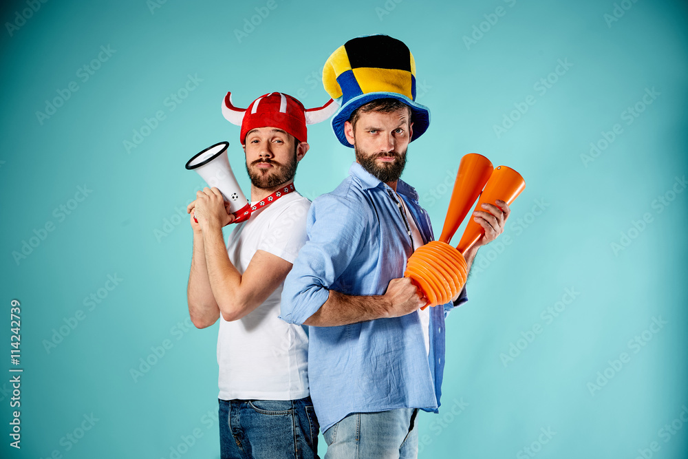 The two football fans with mouthpiece over blue The two football fans with mouthpiece over blue