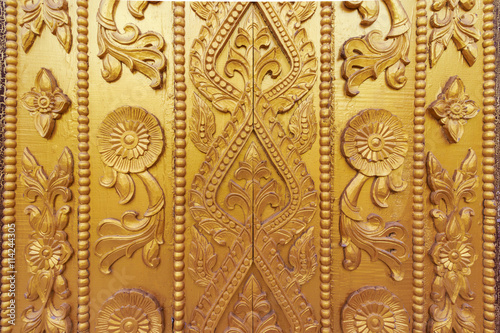 Wood carving on the wall in Myanmar. Myanmar carving on golden wall.