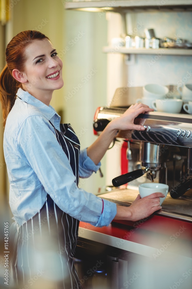 Portrait of happy waitress using espresso machine Portrait of happy waitress using espresso machine