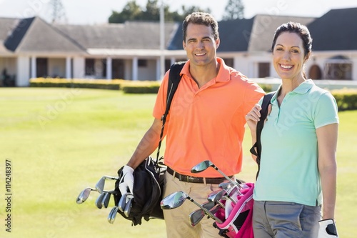 Portrait of couple carrying golf bags  © WavebreakmediaMicro