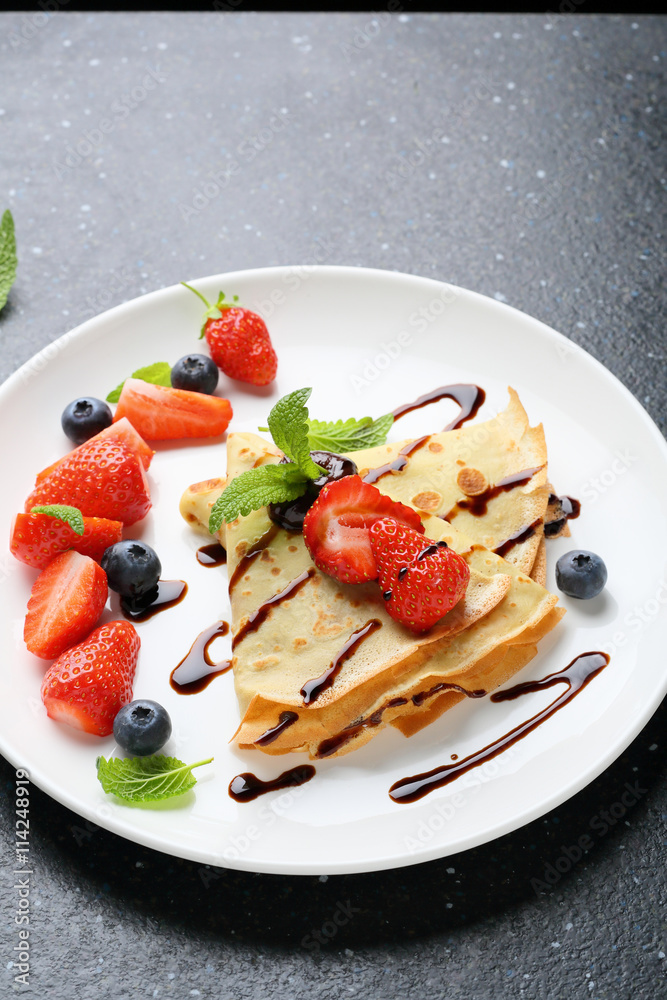 pancake with strawberry on white plate
