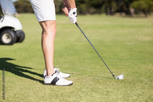 Low section of young man playing golf 
