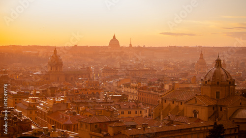 Urban scenic of Rome with dome and churches on the sunset. Italy.