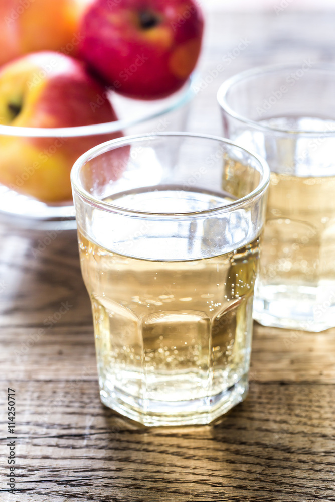 Two glasses of cider on the wooden background Two glasses of cider on the wooden background