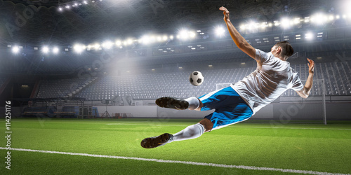 Soccer player hitting ball . Mixed media © Sergey Nivens