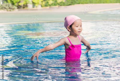 Asian girl is playing in the pool © bjginny