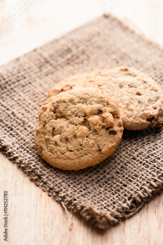 Chocolate cookies on white linen napkin on wooden table. Chocola photo