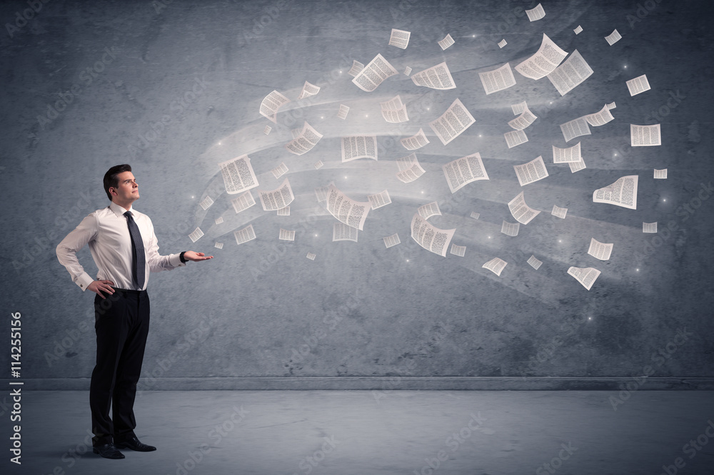 Caucasian businessman holding newspapers