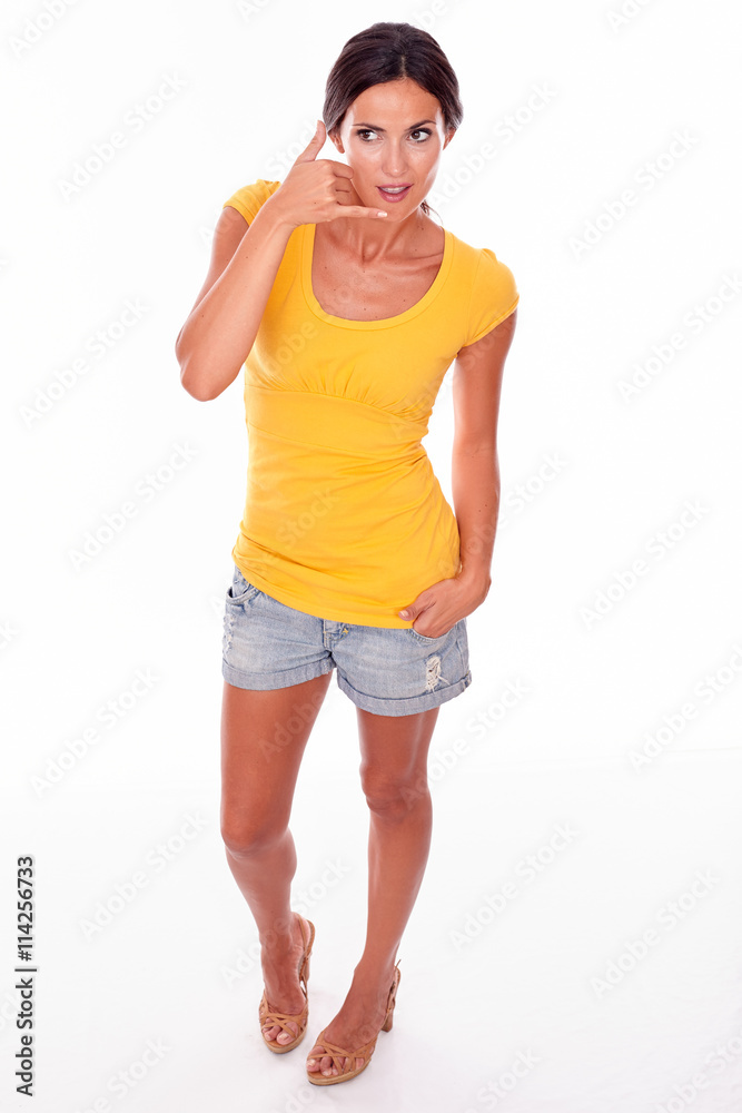 Smiling brunette gesturing a phone call Smiling brunette gesturing a phone call