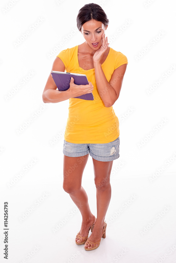 Thinking young brunette with a tablet pc Thinking young brunette with a tablet pc