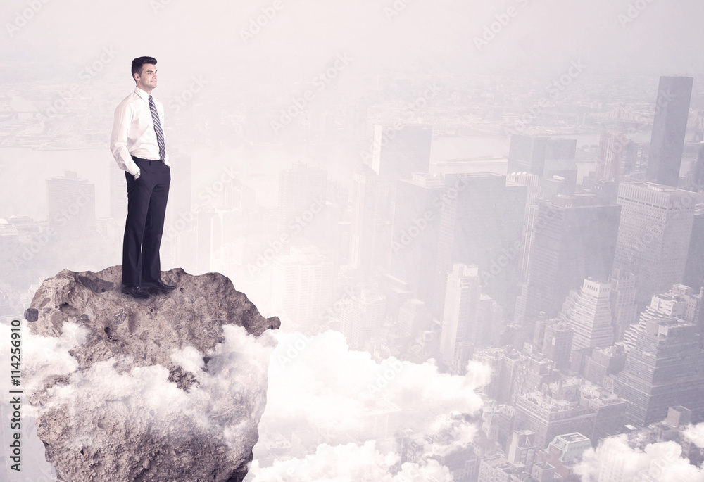 Winner business person standing on rock Winner business person standing on rock