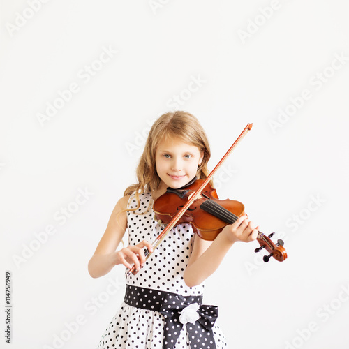 Portrait of girl with string and playing violin photo