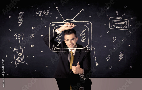 Happy businessman drawing tv and radio