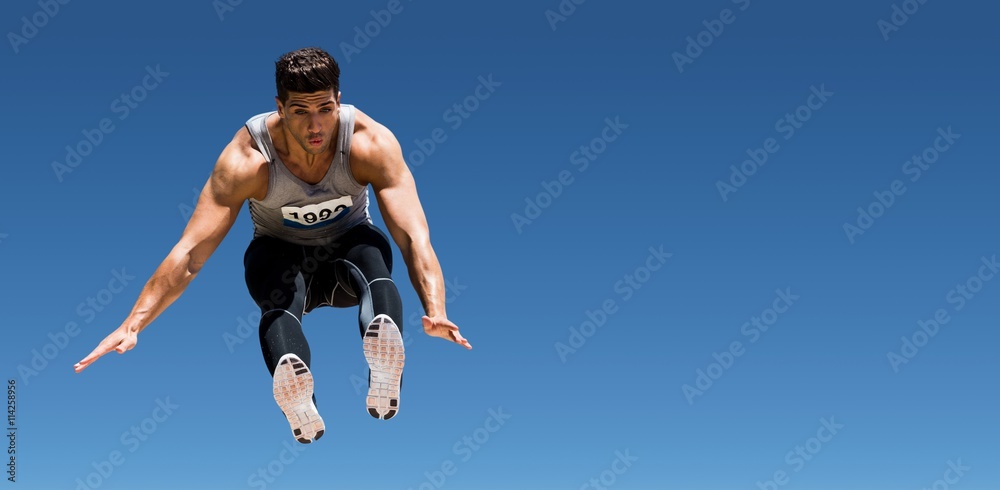 Obraz premium Composite image of front view of sportsman is jumping