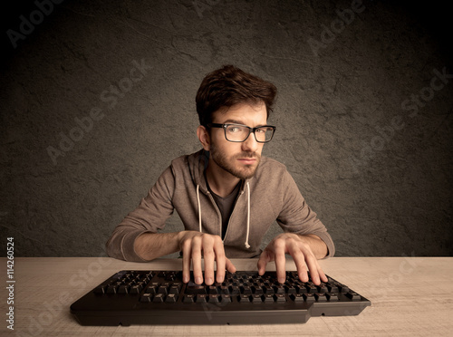 Computer geek typing on keyboard