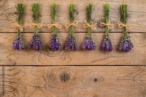 Fototapeta Naklejka Na Ścianę i Meble -  bouquets of lavender over an old rustic wooden background