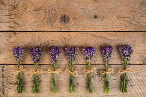 Fototapeta Naklejka Na Ścianę i Meble -  bouquets of lavender over an old rustic wooden background
