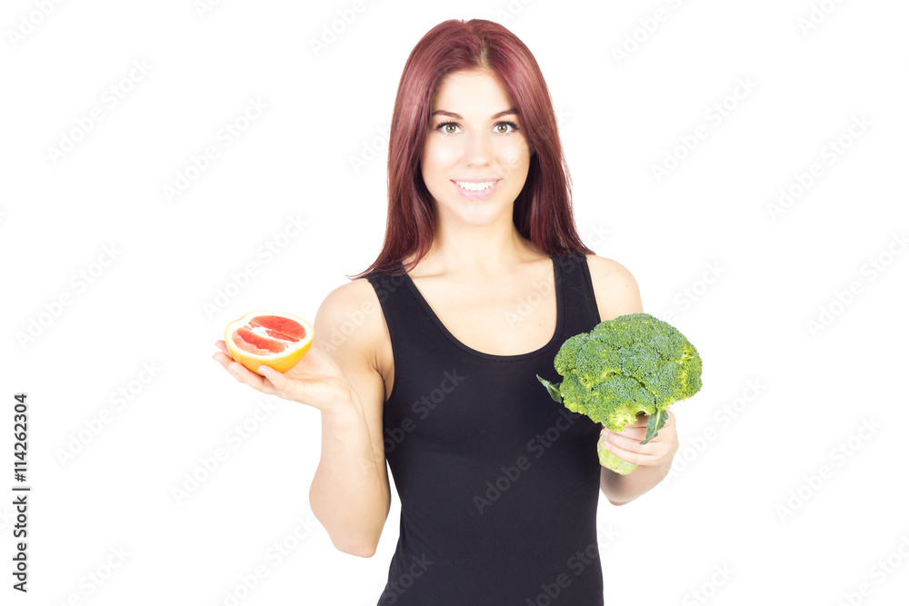 Smiling beauty woman showing grapefruit and broccoli. Woman sitting on a diet. Vegan food. Smiling beauty woman showing grapefruit and broccoli. Woman sitting on a diet. Vegan food.