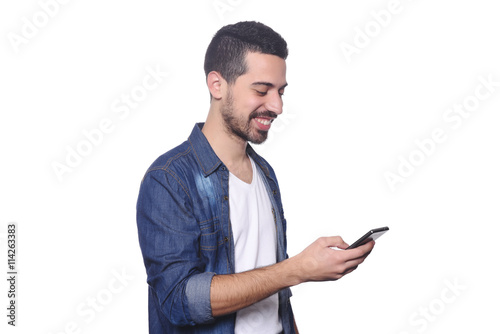 Young latin man typing on his smartphone.