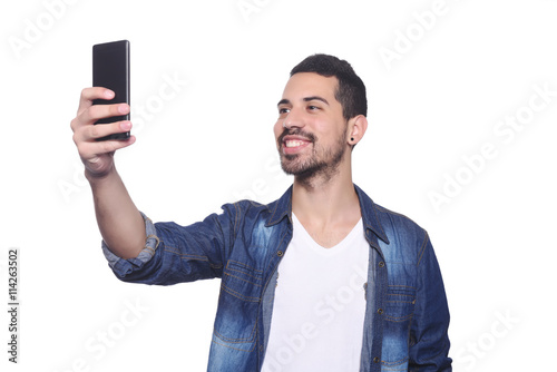 Young man taking a selfie with his smartphone. © Mego-studio